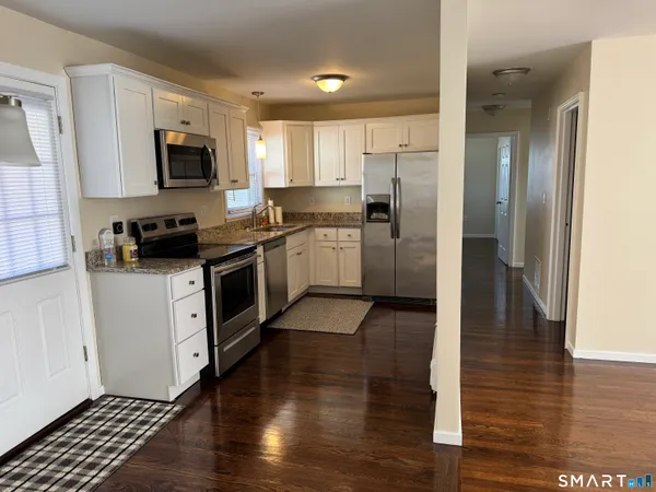 a kitchen with a sink and a stove top oven