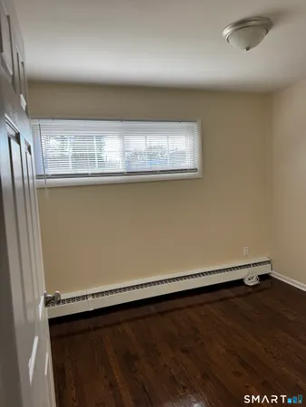 an empty room with wooden floor
