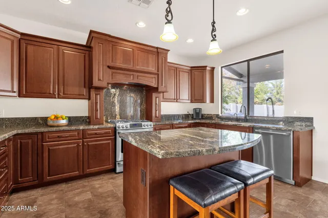 a kitchen with center island a sink dining table and chairs