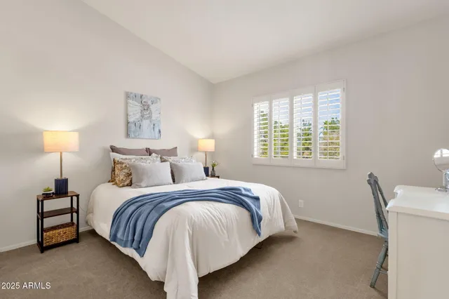 a bed room with a bed and a window