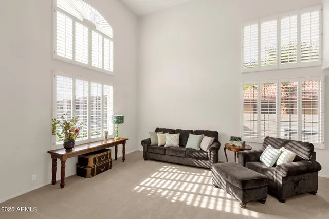 a living room with furniture fireplace and a window