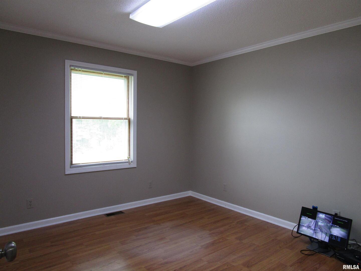 1253 County Road 800 East Carmi, IL 62821 - Photo 13 of 51 an empty room with wooden floor and windows