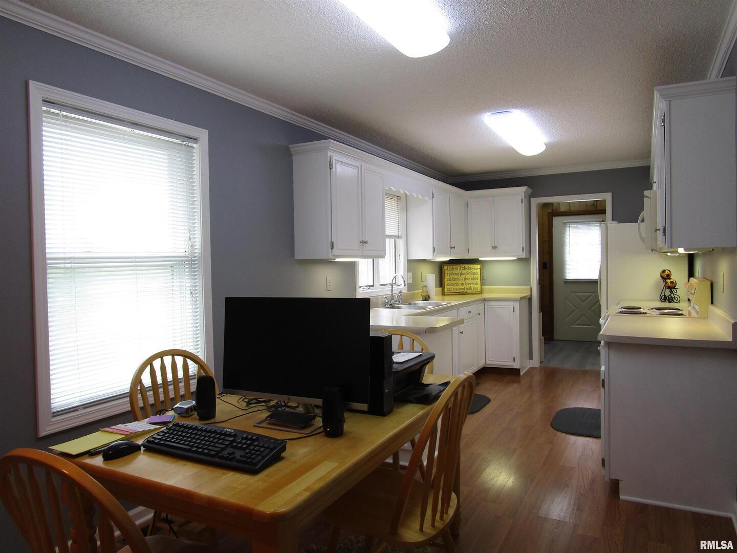 1253 County Road 800 East Carmi, IL 62821 - Photo 15 of 51 a kitchen with a stove a sink and a refrigerator