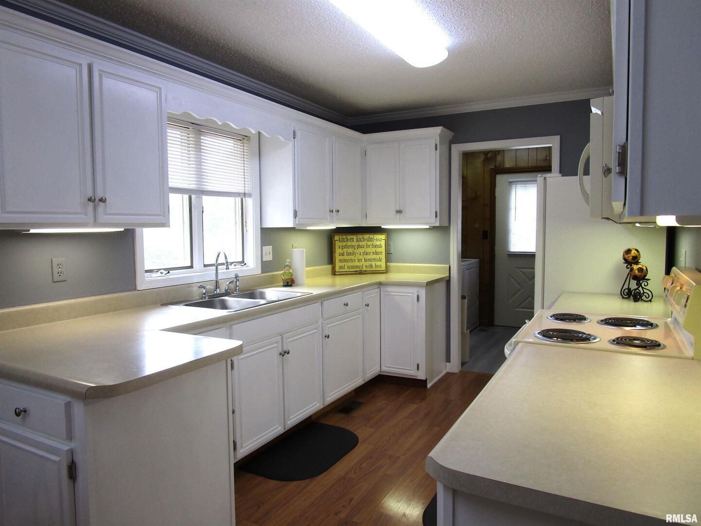 1253 County Road 800 East Carmi, IL 62821 - Photo 16 of 51 a kitchen with a sink stove and cabinets