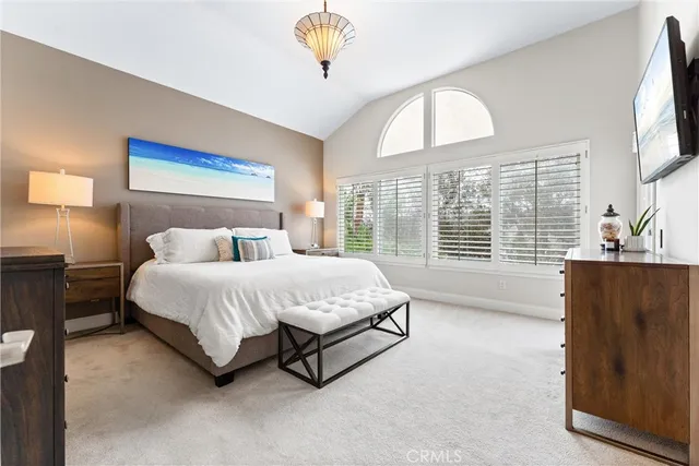 a bedroom with a bed and a large mirror