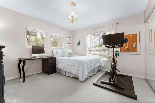 a view of a workspace with furniture and a bookshelf