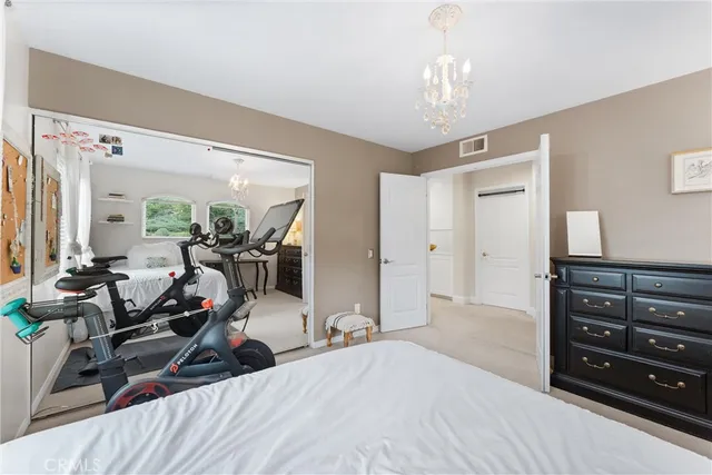 a spacious bedroom with a bed and a desk