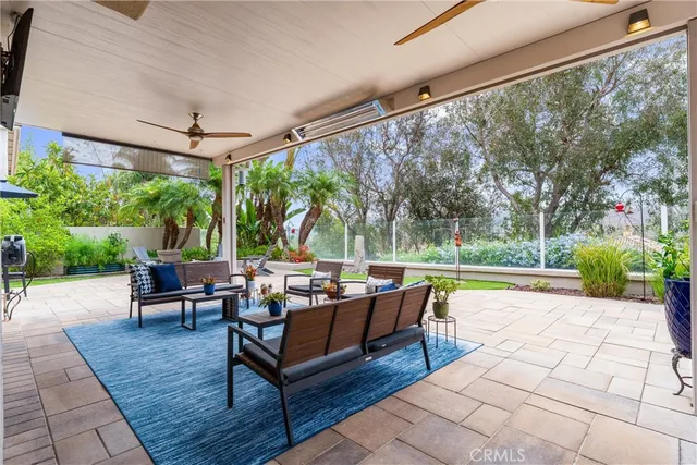 a view of a patio with chairs and potted plants