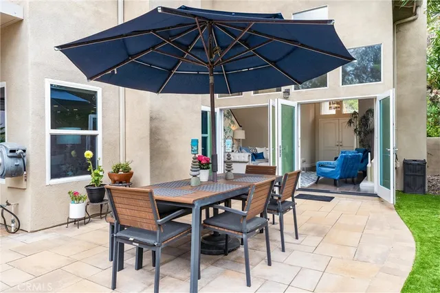 an aerial view of a house with a garden space and street view