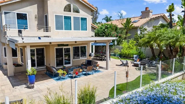 an aerial view of house with yard and mountain in the background