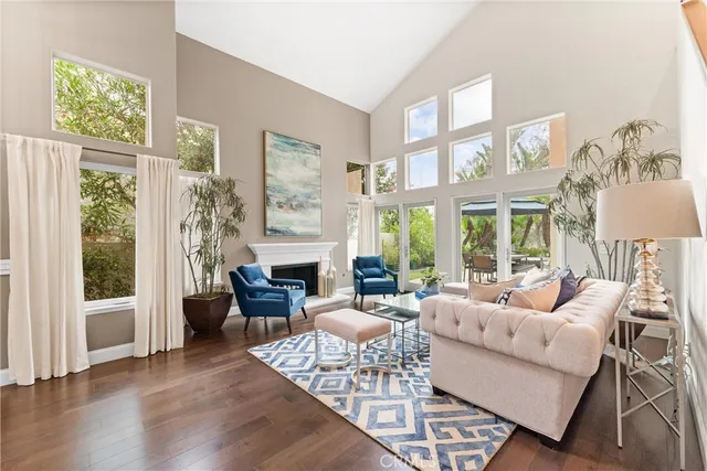a living room with fireplace furniture and a large window