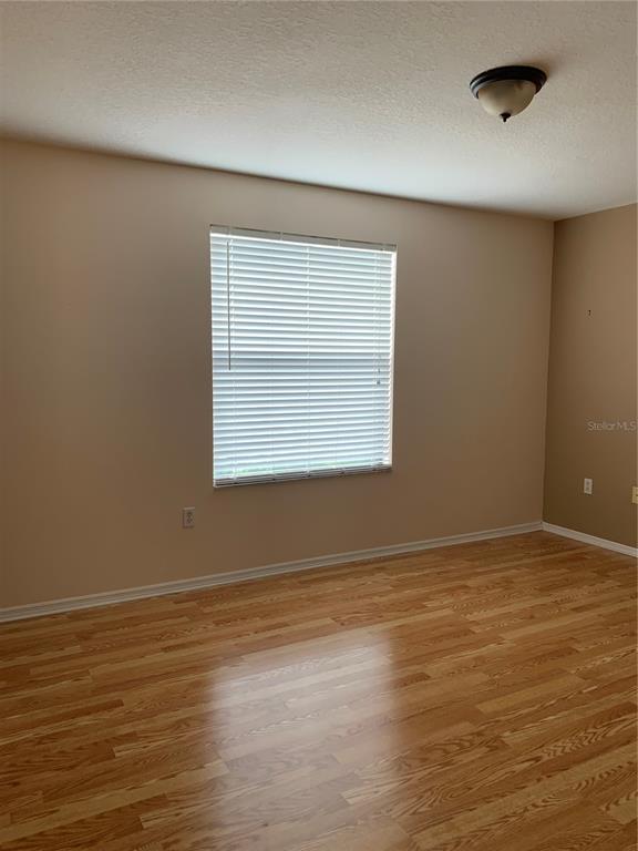 1531 Water Terrace Lane Brandon, FL 33511 - Photo 7 of 14 an empty room with wooden floor and windows