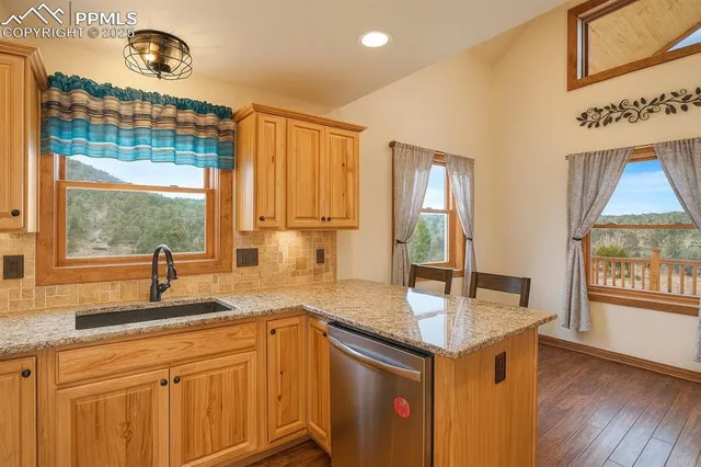 a kitchen with granite countertop a sink and a window