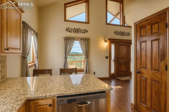 a kitchen with stainless steel appliances granite countertop a sink and a refrigerator