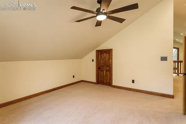 an empty room with a ceiling fan and a window