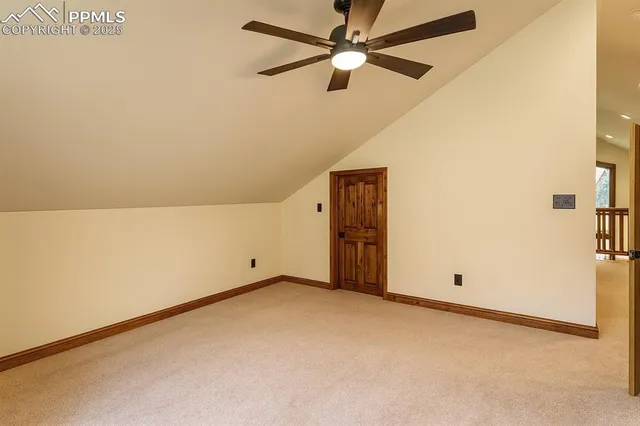 an empty room with a ceiling fan and a window