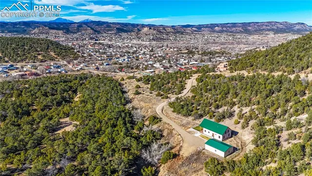 an aerial view of a house with a yard
