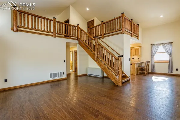 a view of staircase with white walls and a window