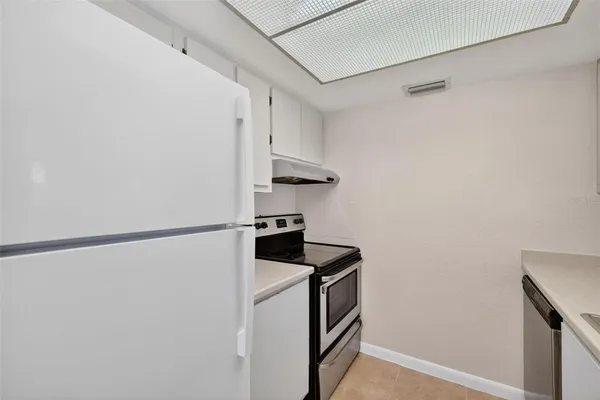 a kitchen with a stove and a refrigerator