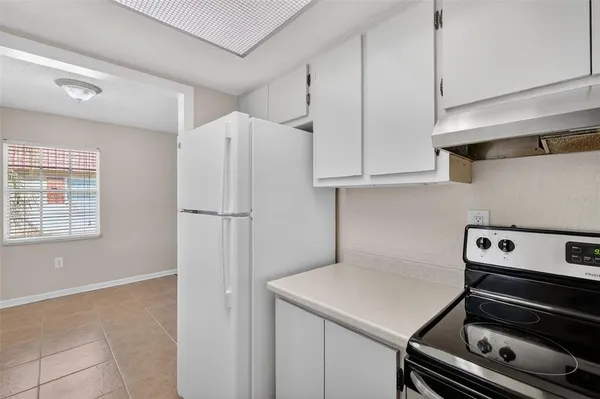 a kitchen with a sink cabinets and window