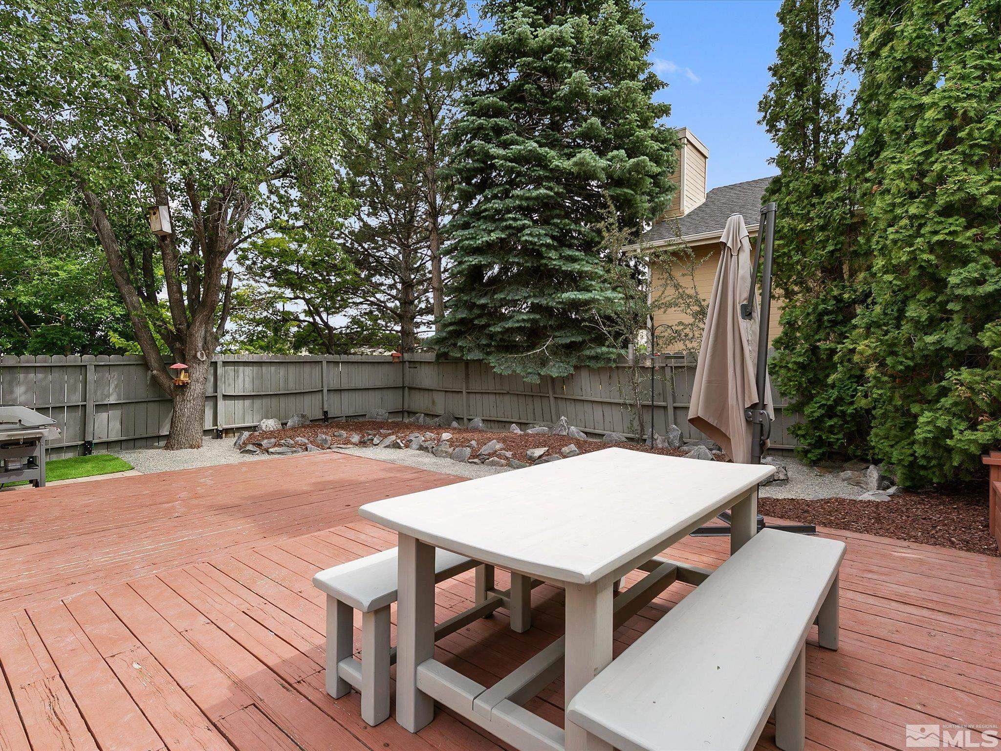 2860 Alpine Creek Road Reno, NV 89519 - Photo 29 of 39 a view of a patio with table and chairs with wooden floor and fence