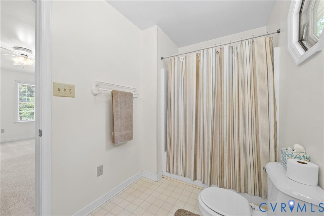 2924 Warfield Ridge Terrace Chester, VA 23831 - Photo 31 of 38 Bathroom featuring a shower with a striped curtain
