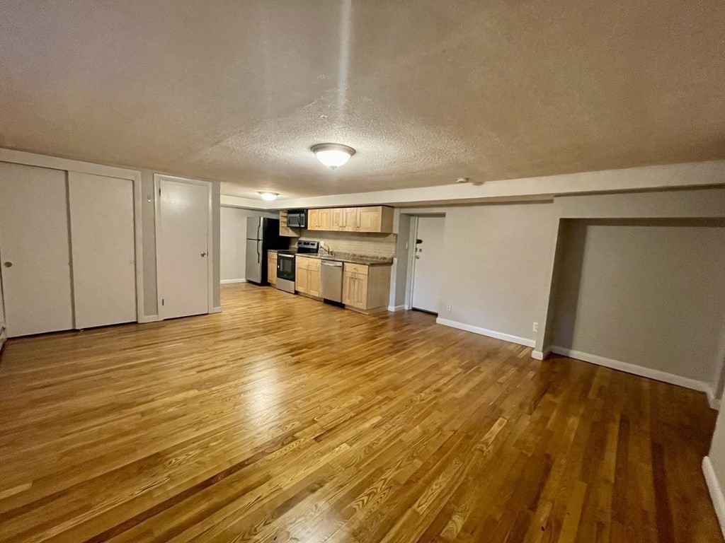21 Westgate Road, Unit 2 Chestnut Hill, MA 02467 - Photo 5 of 8 a view of empty room with wooden floor