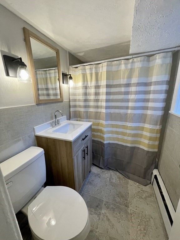 21 Westgate Road, Unit 2 Chestnut Hill, MA 02467 - Photo 6 of 8 a bathroom with a sink mirror vanity and toilet
