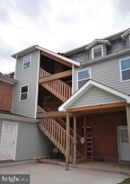 12439 Old Frederick Road, Unit 6 Thurmont, MD 21788 - Photo 12 of 15 a view of a house with wooden stairs