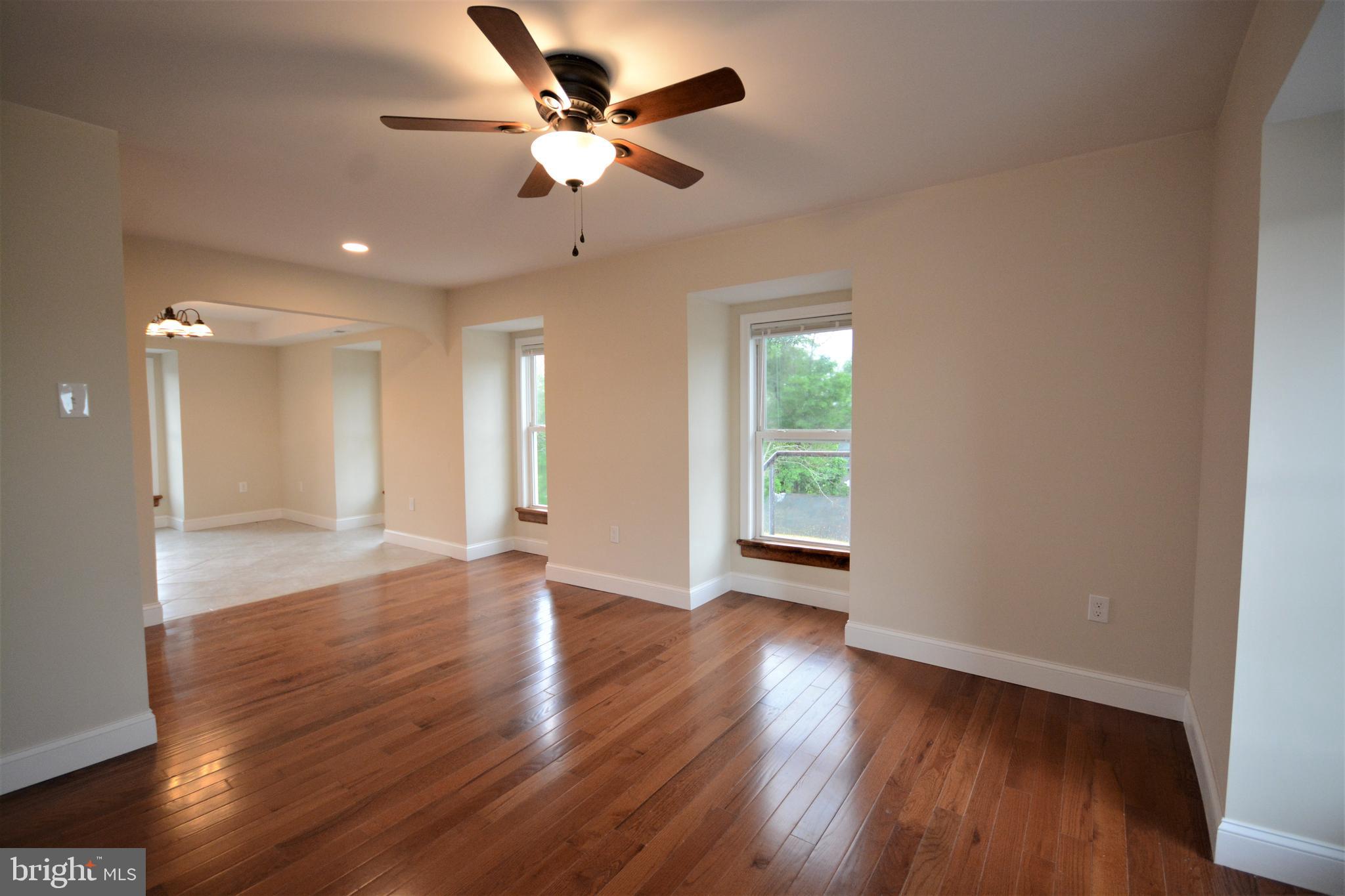 12439 Old Frederick Road, Unit 6 Thurmont, MD 21788 - Photo 5 of 15 a view of an empty room with wooden floor and a window