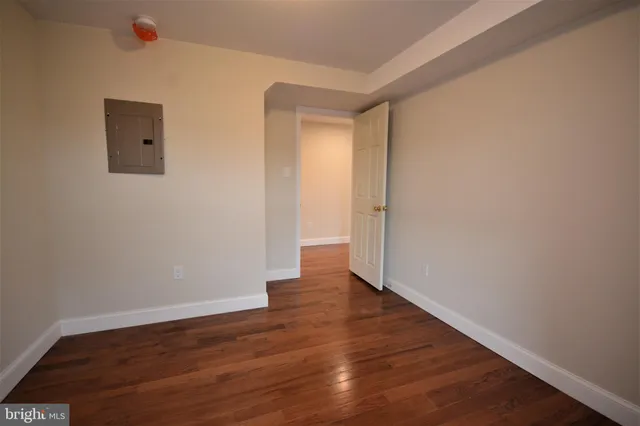 a view of an empty room with wooden floor