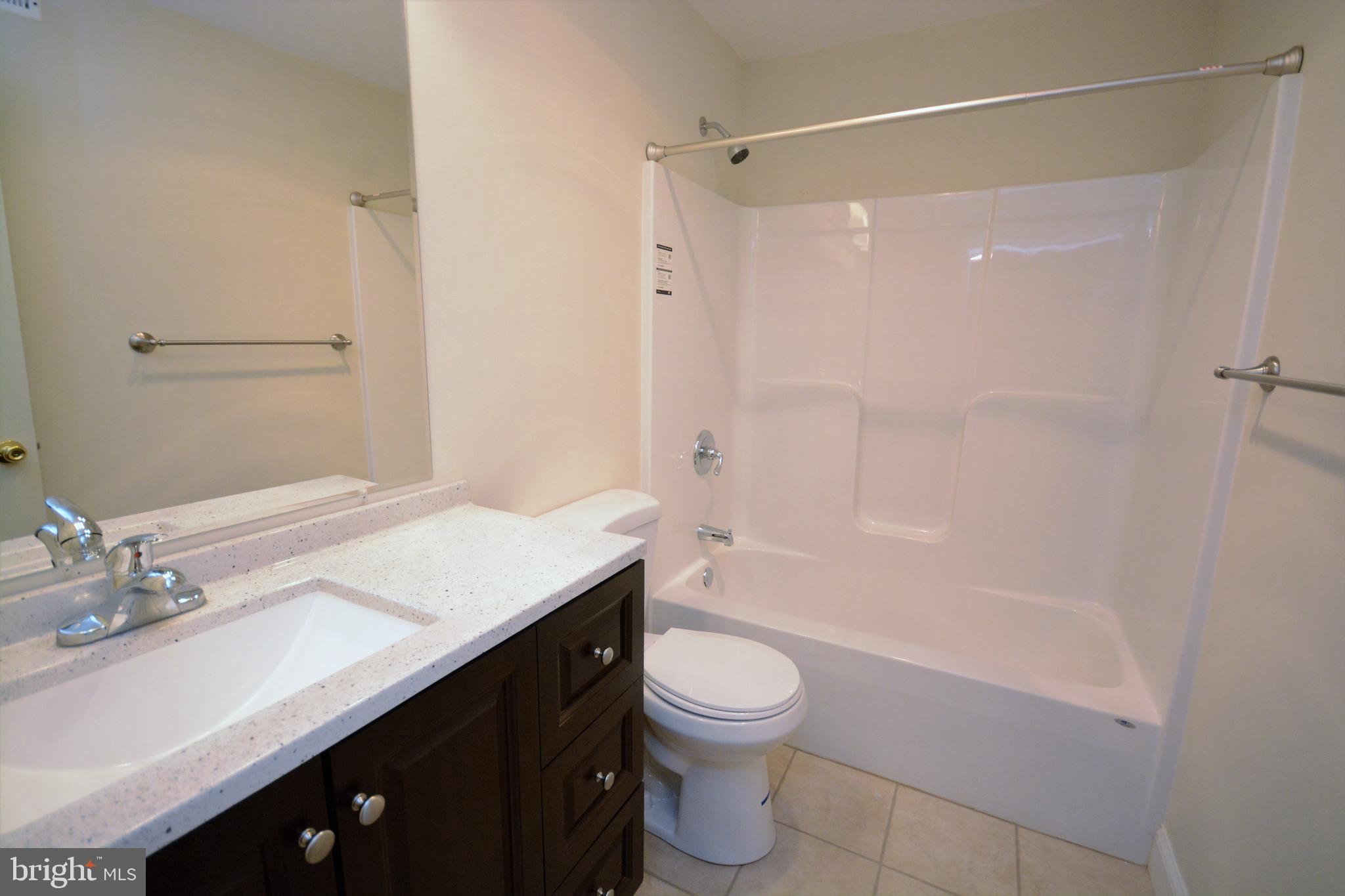 12439 Old Frederick Road, Unit 6 Thurmont, MD 21788 - Photo 10 of 15 a bathroom with a sink a toilet and shower