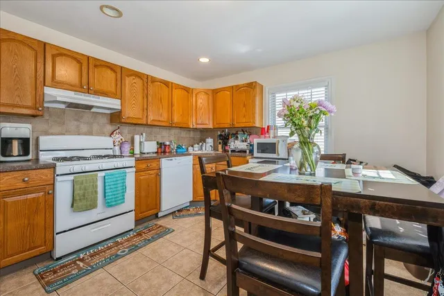 a room with stainless steel appliances a stove a sink dishwasher and cabinets