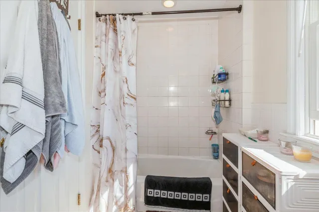 a bathroom with a shower curtain and a sink