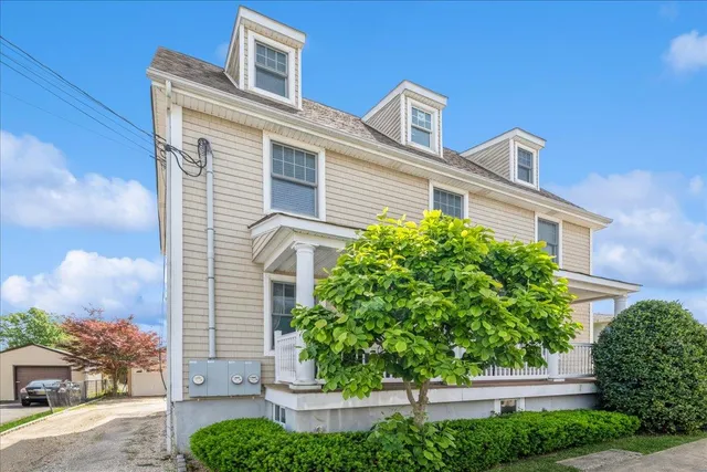 a front view of a house with plants