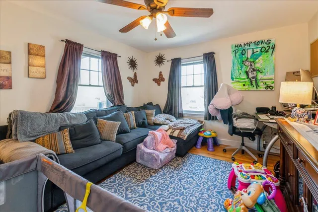 a living room with furniture fireplace and a window