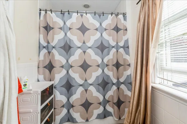 a bathroom with a sink and a shower curtain