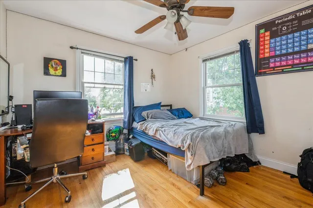 a bedroom with a bed and wooden floor