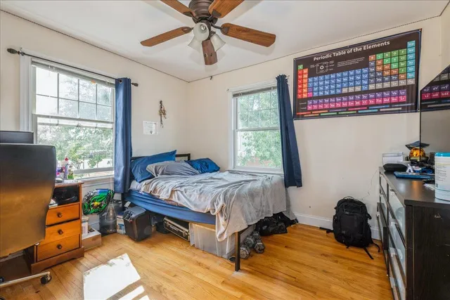 a bedroom with a bed and a window