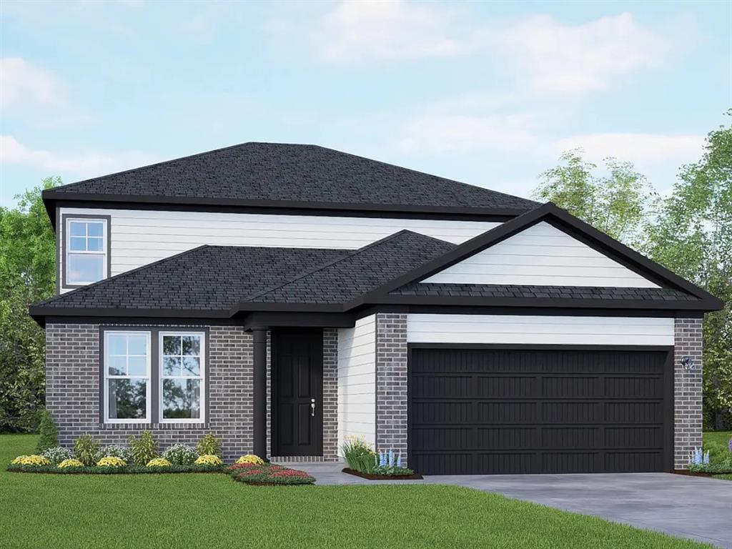 View of front facade with brick siding, a garage, a front lawn, and driveway