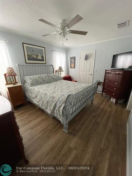 Park City Davie, FL 33324 - Photo 15 of 22 a bedroom with a bed and wooden floor