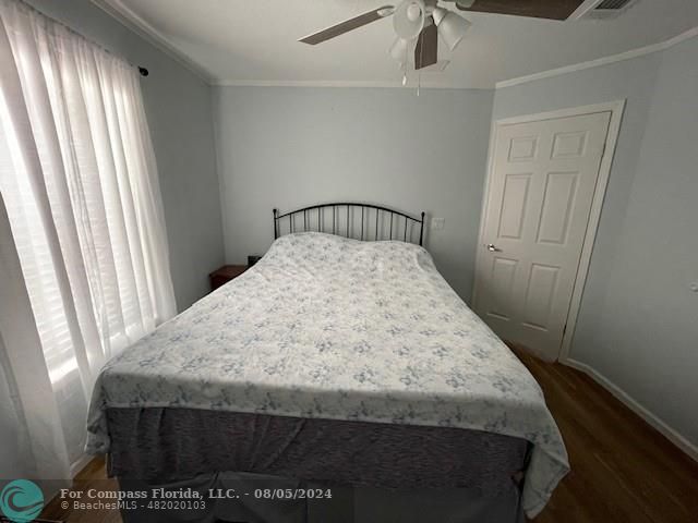 Park City Davie, FL 33324 - Photo 18 of 22 a bed sitting in a bedroom next to a window