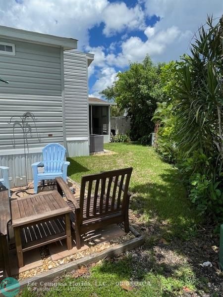 Park City Davie, FL 33324 - Photo 7 of 22 a view of a chairs and table in backyard