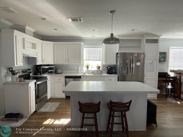 Park City Davie, FL 33324 - Photo 8 of 22 a large kitchen with granite countertop a stove a sink a refrigerator and a dining table