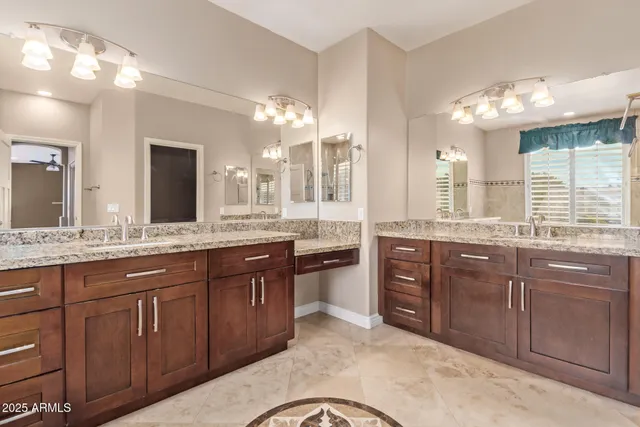 a bathroom with a granite countertop sink and a bathtub