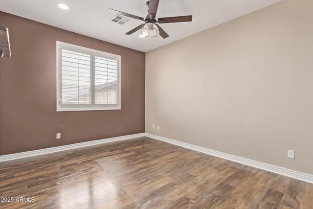 a view of a hallway with closet and wooden floor