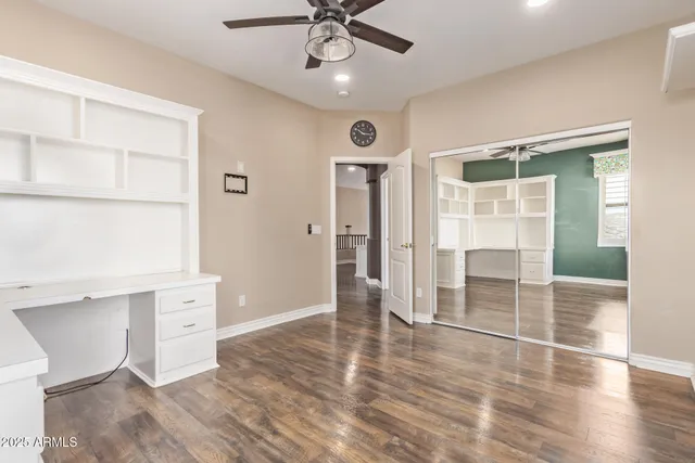 a view of a livingroom with a ceiling fan and window