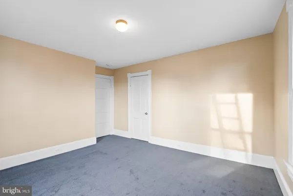 a view of an empty room and a window