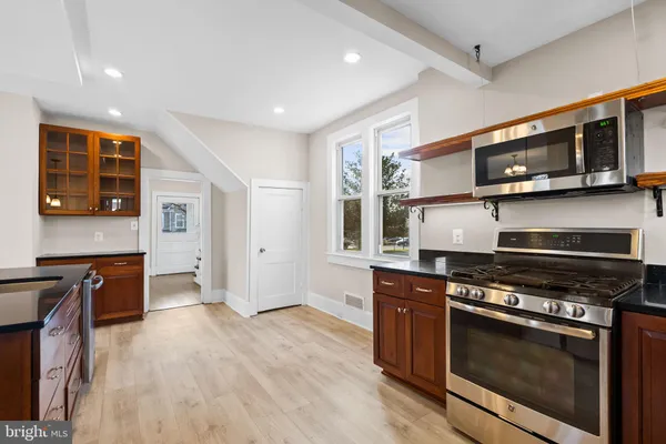 a kitchen with stainless steel appliances a stove microwave and sink