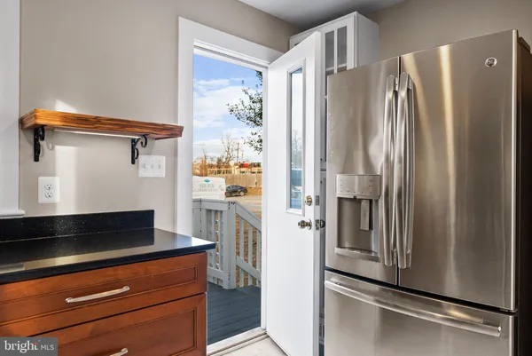 a kitchen with stainless steel appliances a refrigerator and a stove top oven
